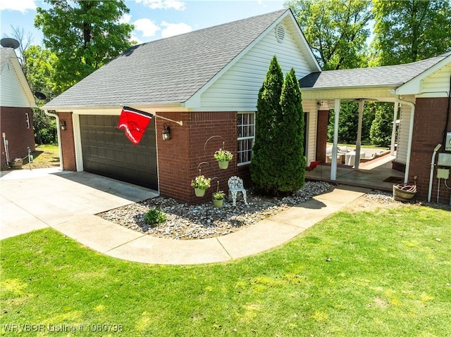 view of front of home with brick siding, roof with shingles, and a front lawn