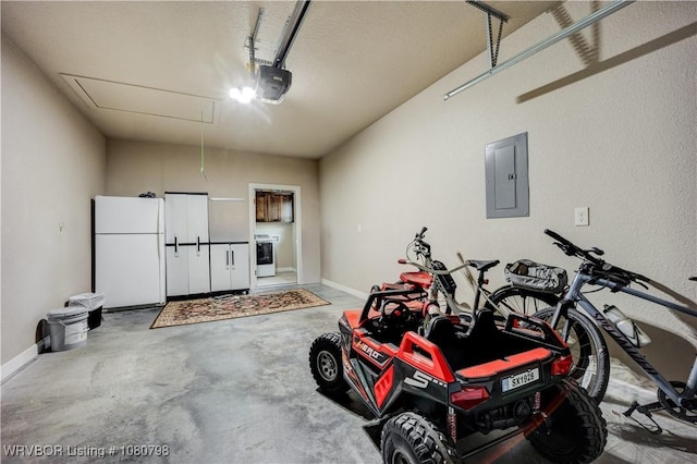 garage with electric panel, washer / clothes dryer, freestanding refrigerator, a garage door opener, and baseboards