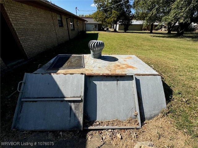 view of storm shelter with a lawn