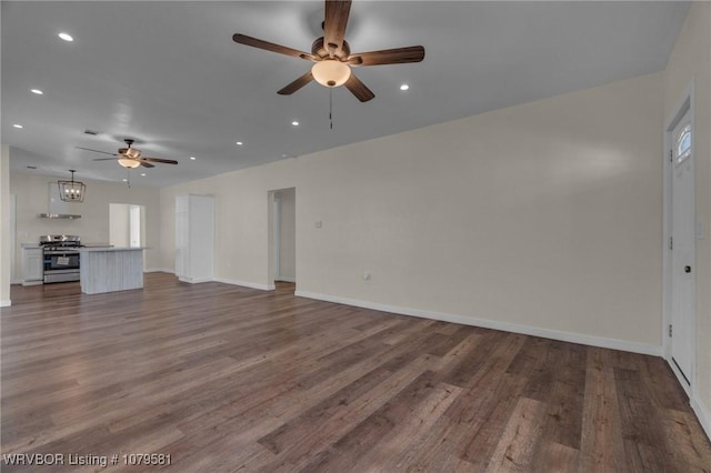 unfurnished living room featuring recessed lighting, baseboards, and wood finished floors