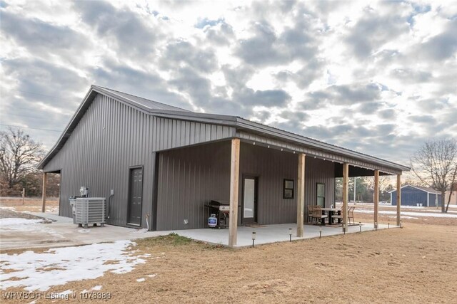 back of house featuring cooling unit and a patio