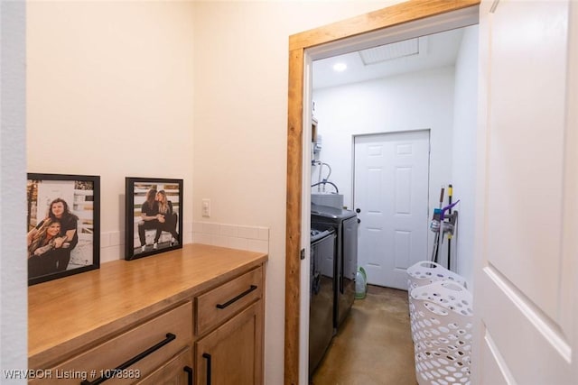 hallway with washing machine and dryer