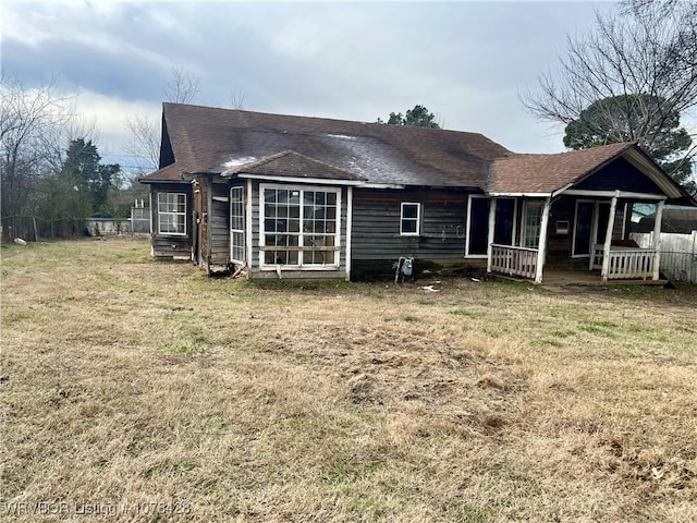 back of property with a porch and a lawn