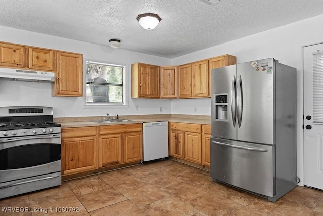 4308 25th St, Fort Smith, AR 72901 - kitchen featuring a sink, a textured ceiling, under cabinet range hood, light countertops, and appliances with stainless steel finishes