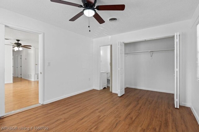 4308 25th St, Fort Smith, AR 72901 - unfurnished bedroom with a closet, wood finished floors, a textured ceiling, visible vents, and ceiling fan