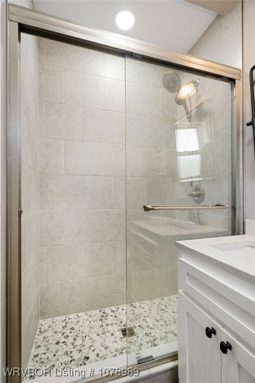 bathroom with a stall shower and vanity