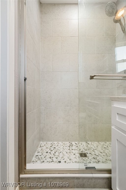 full bath with a shower stall and vanity