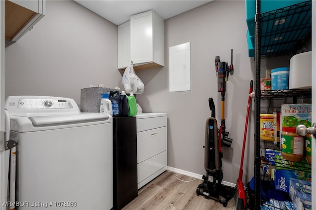 clothes washing area with cabinet space, light wood-style flooring, electric panel, independent washer and dryer, and baseboards