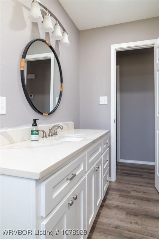 bathroom featuring wood finished floors and vanity