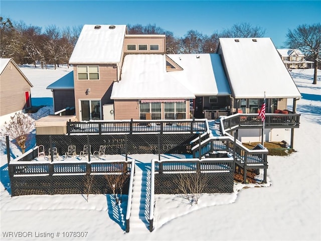 snow covered property with a wooden deck