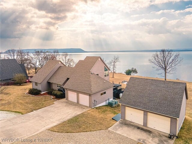 snowy aerial view featuring a water view