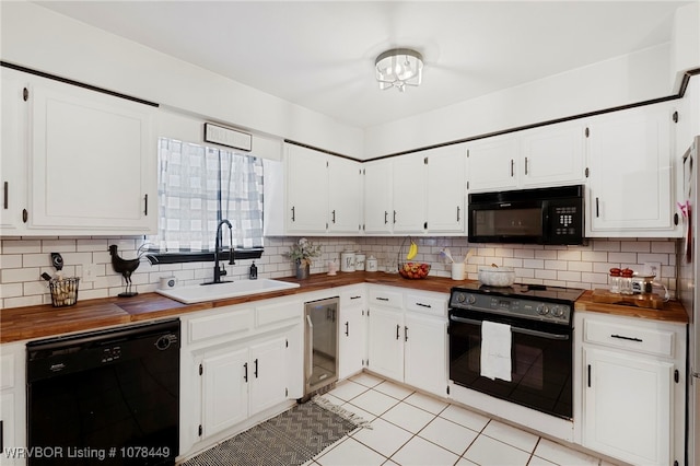 kitchen with sink, white cabinetry, black appliances, and wooden counters