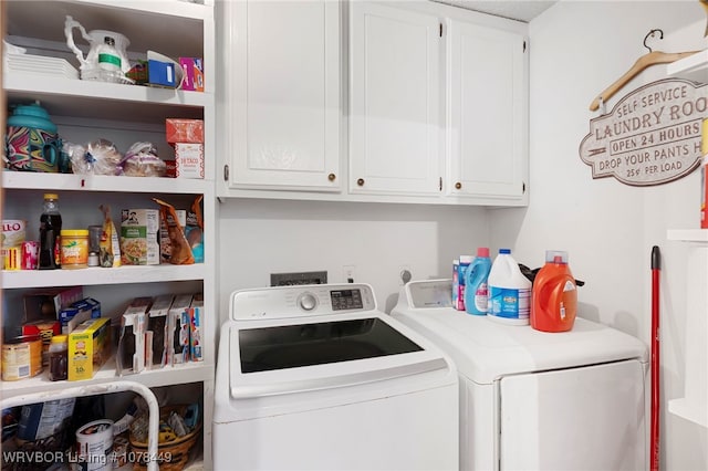 laundry area featuring separate washer and dryer and cabinets