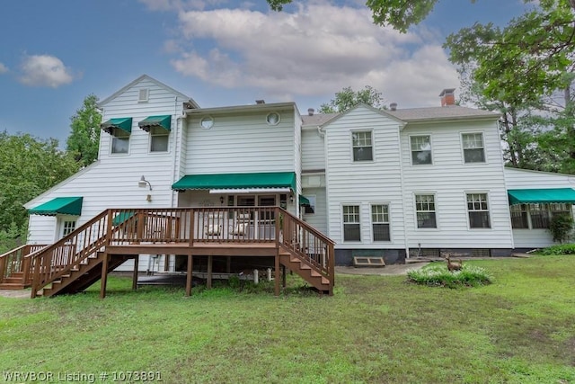 rear view of property with a yard and a wooden deck