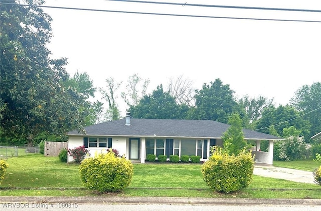 single story home with fence, a front lawn, an attached carport, and driveway