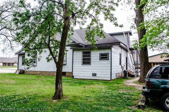 view of property exterior with a yard