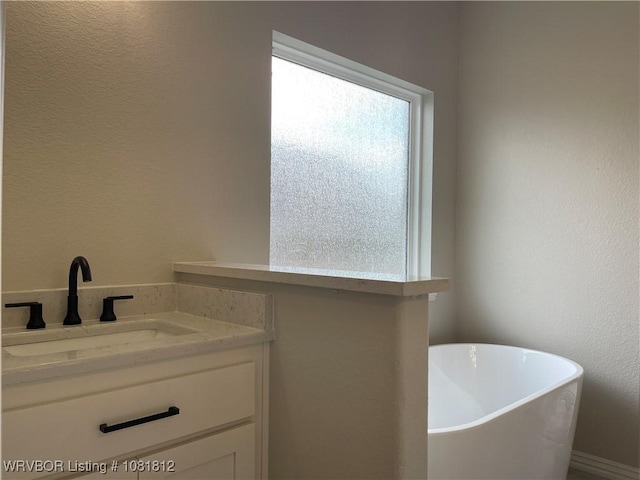 9109 Wayne Xing, Fort Smith, AR 72916 - bathroom with a freestanding tub, vanity, and a textured wall