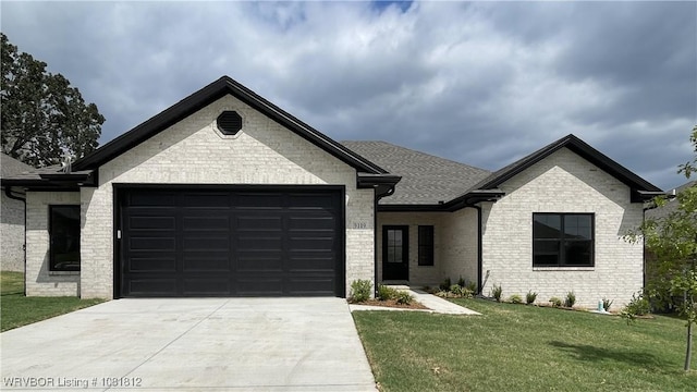 9109 Wayne Xing, Fort Smith, AR 72916 - view of front of home featuring an attached garage, concrete driveway, a front yard, and brick siding