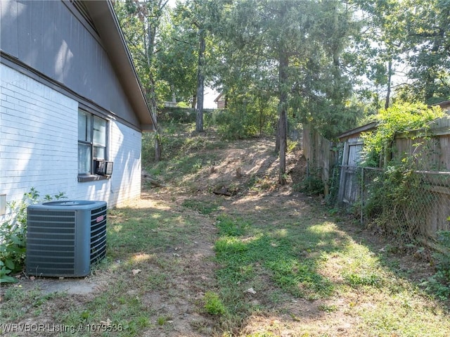 view of yard with cooling unit and fence