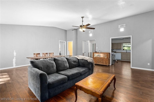 living area with dark wood-style floors, visible vents, baseboards, and vaulted ceiling