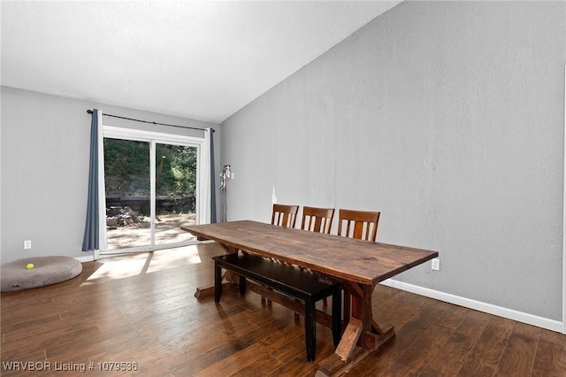 dining room with vaulted ceiling, baseboards, and wood-type flooring