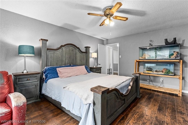 bedroom with ceiling fan, baseboards, wood-type flooring, and a textured ceiling