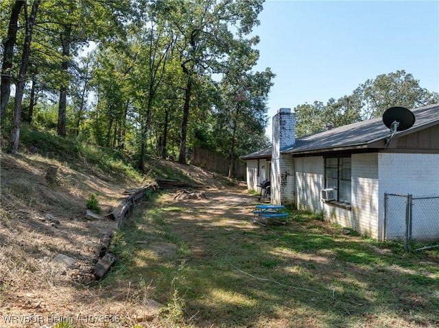 view of yard with cooling unit and fence