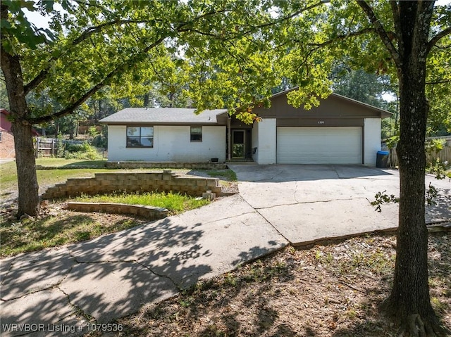 single story home with a garage and driveway