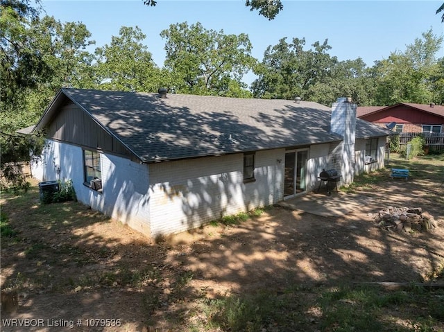 view of home's exterior with roof with shingles and a chimney