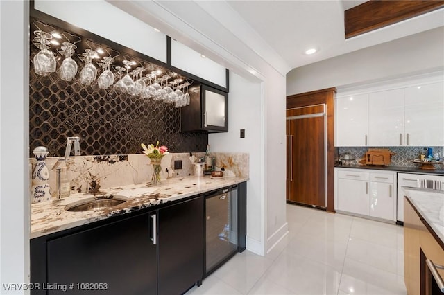 4110 S 34th St, Fort Smith, AR 72903 - indoor wet bar with beverage cooler, tasteful backsplash, light tile patterned floors, paneled fridge, and dishwasher