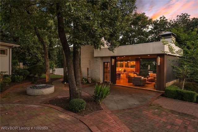 4110 S 34th St, Fort Smith, AR 72903 - patio terrace at dusk featuring an outdoor hangout area and a patio