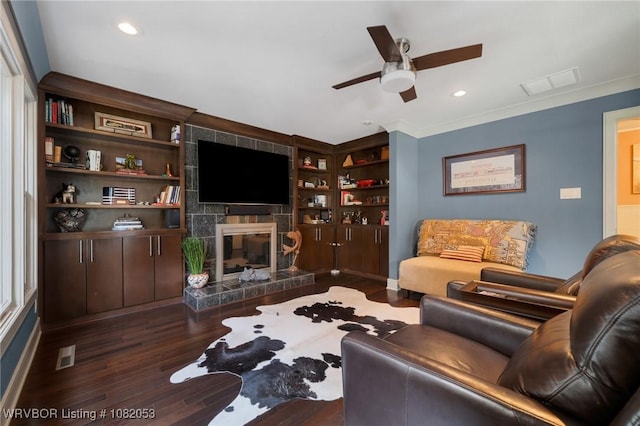 4110 S 34th St, Fort Smith, AR 72903 - living room with a ceiling fan, wood finished floors, a tile fireplace, built in shelves, and ornamental molding