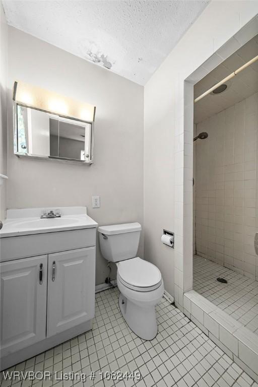 121 Dartmouth Ln, Fort Smith, AR 72908 - full bathroom with a stall shower, vanity, a textured ceiling, and tile patterned flooring