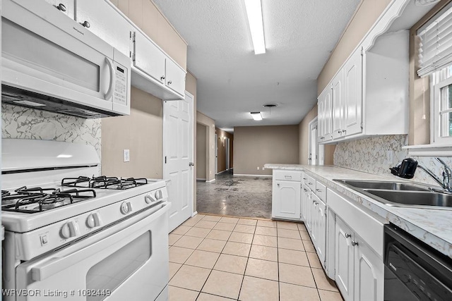 121 Dartmouth Ln, Fort Smith, AR 72908 - kitchen featuring white appliances, white cabinets, backsplash, light countertops, and a textured ceiling
