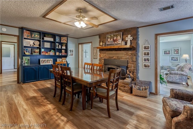 3001 Coral Cir, Alma, AR 72921 - dining area featuring a textured ceiling, ornamental molding, light wood-style floors, and a ceiling fan
