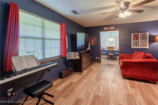 3001 Coral Cir, Alma, AR 72921 - living room with a textured ceiling, ceiling fan, and wood finished floors