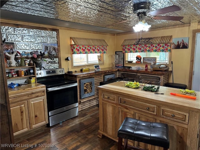 kitchen featuring stainless steel electric stove, dark hardwood / wood-style flooring, ceiling fan, and butcher block countertops