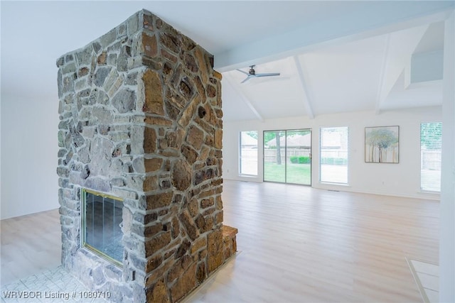 unfurnished living room with vaulted ceiling with beams, a ceiling fan, wood finished floors, and a fireplace