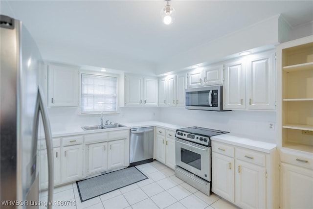 kitchen with a sink, light countertops, stainless steel appliances, and white cabinetry