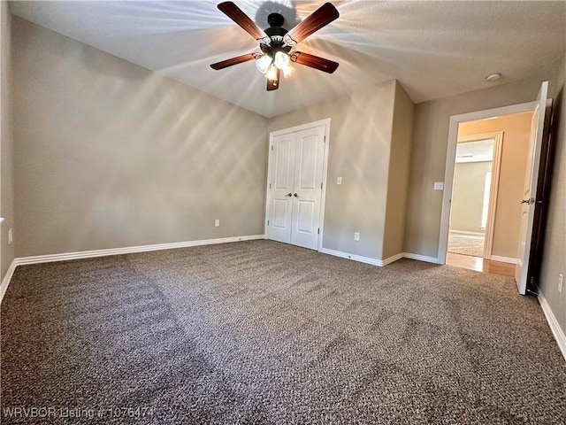 unfurnished bedroom featuring carpet, a closet, and ceiling fan