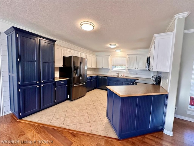 kitchen with dishwasher, stove, blue cabinets, stainless steel refrigerator with ice dispenser, and white cabinetry