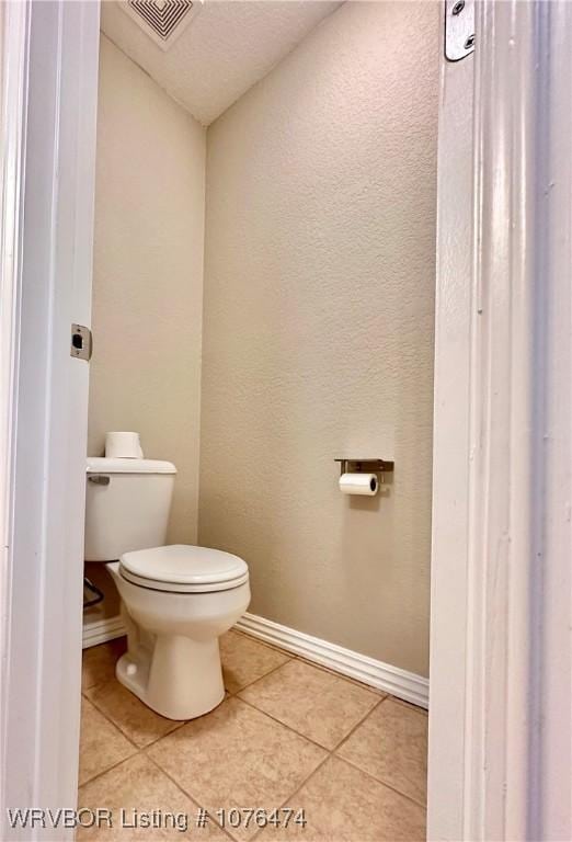 bathroom featuring tile patterned floors and toilet