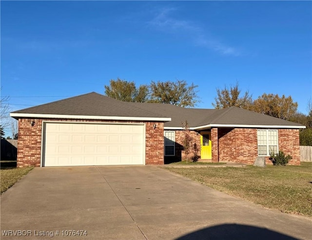 single story home with a garage and a front lawn