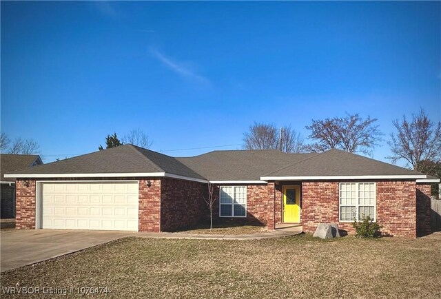 single story home with a garage and a front yard