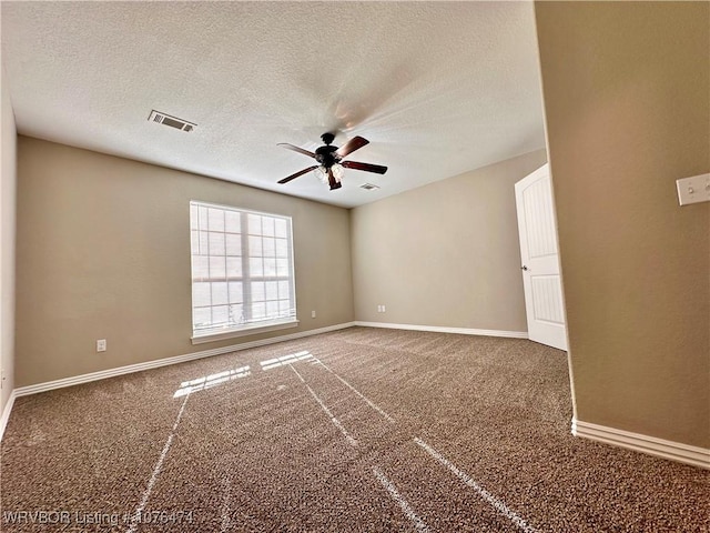 carpeted spare room featuring ceiling fan and a textured ceiling