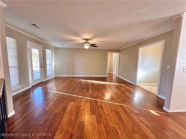 unfurnished room with hardwood / wood-style floors, a textured ceiling, ceiling fan, and crown molding