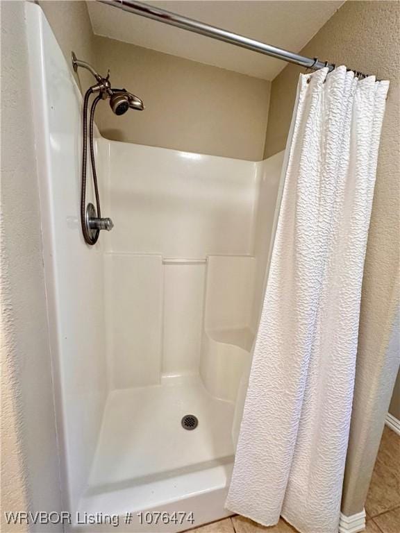 bathroom with tile patterned flooring and curtained shower