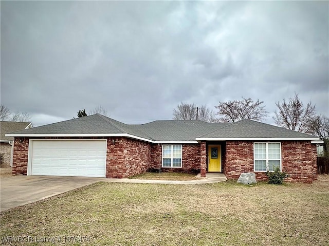 ranch-style house with a garage and a front lawn