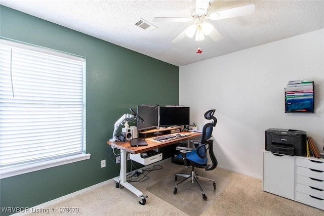 office featuring visible vents, baseboards, a textured ceiling, and ceiling fan