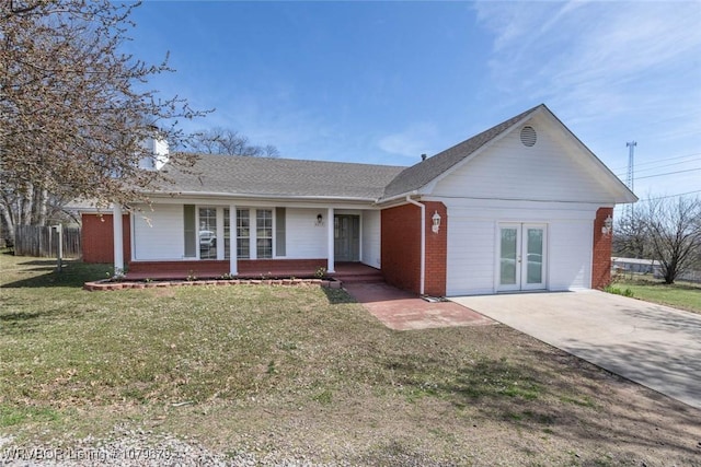 ranch-style house featuring brick siding, french doors, a front yard, and roof with shingles